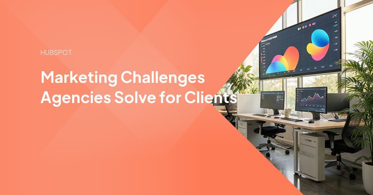 Agency team members working at laptops around a conference table in a glass-walled office, reviewing client marketing work together.