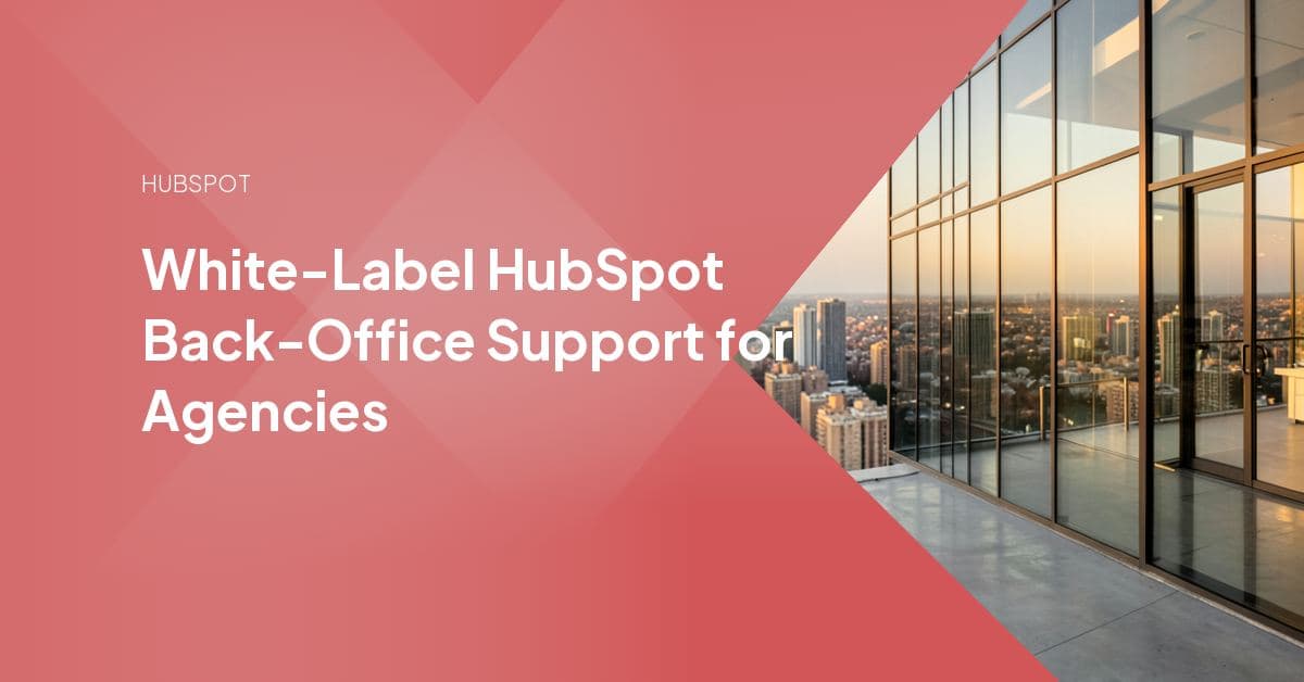 Agency project manager and a white-label HubSpot delivery specialist reviewing a client portal build together under the agency's own branding.